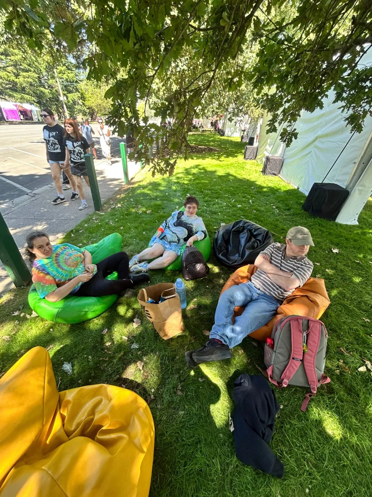 Participants relaxing on bean bags in the shade at a local festival