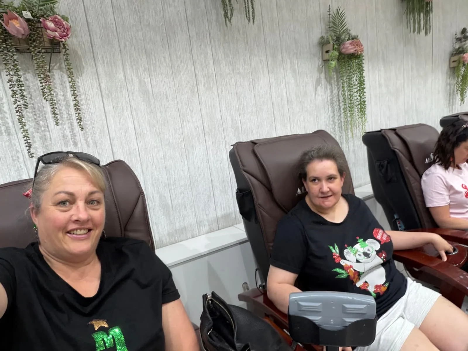 Participant and support worker enjoying a pamper day at the salon