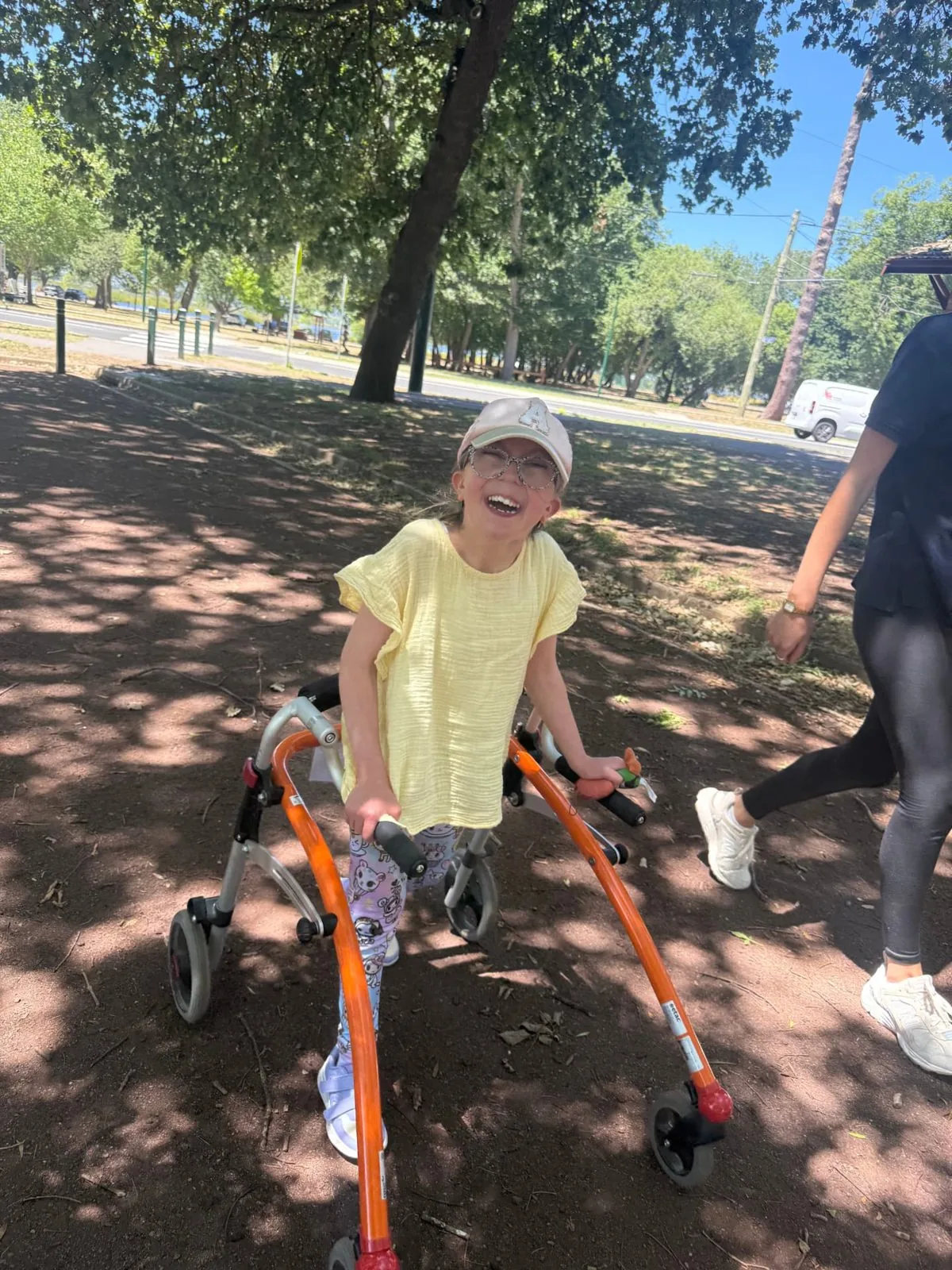 Participant beaming while using her walker in the park