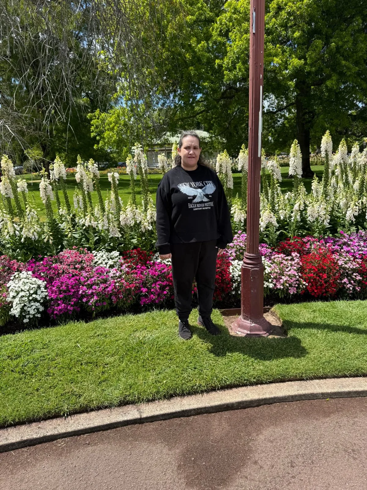 Participant standing among the flower beds in the botanical gardens