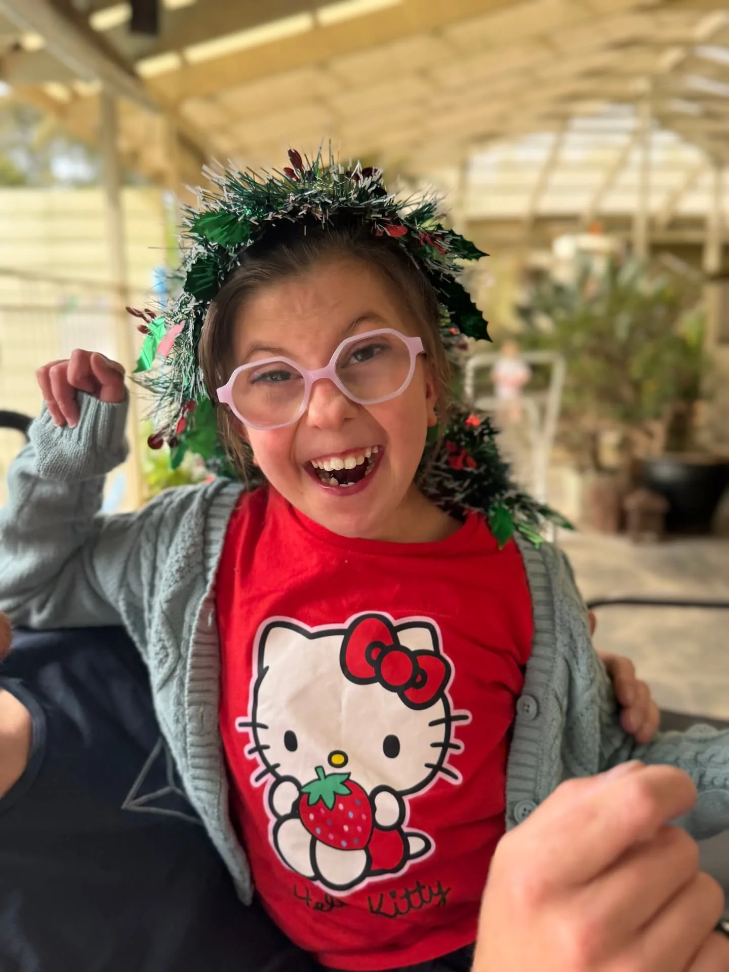 Participant laughing while wearing a Christmas tinsel headband
