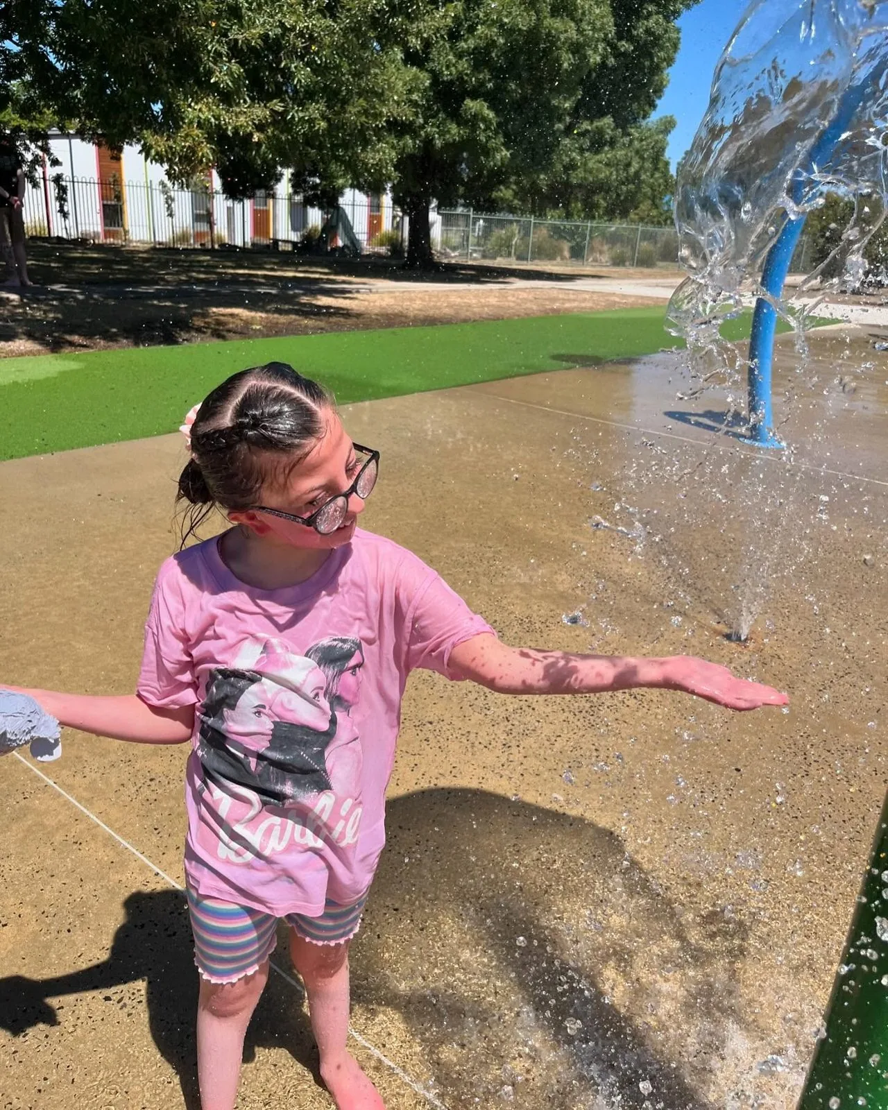 Participant playing in the water at the splash park