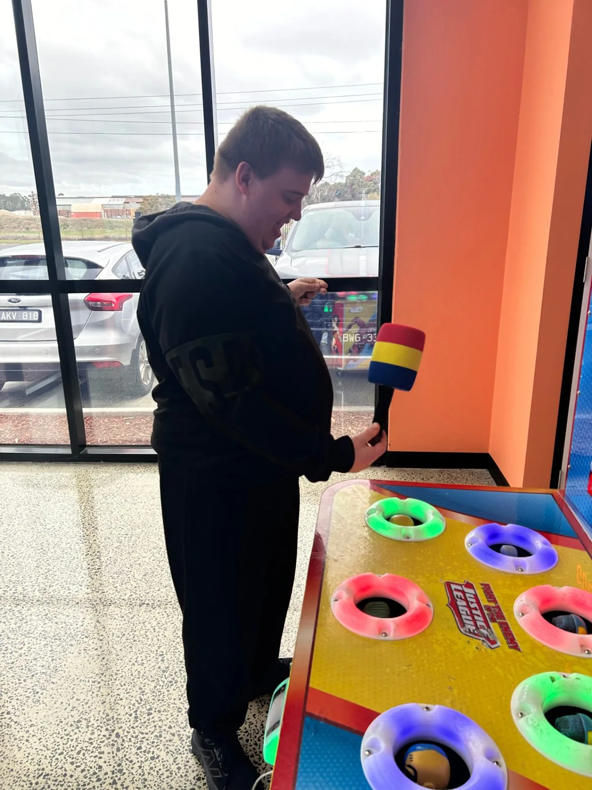 Participant laughing while playing an arcade game