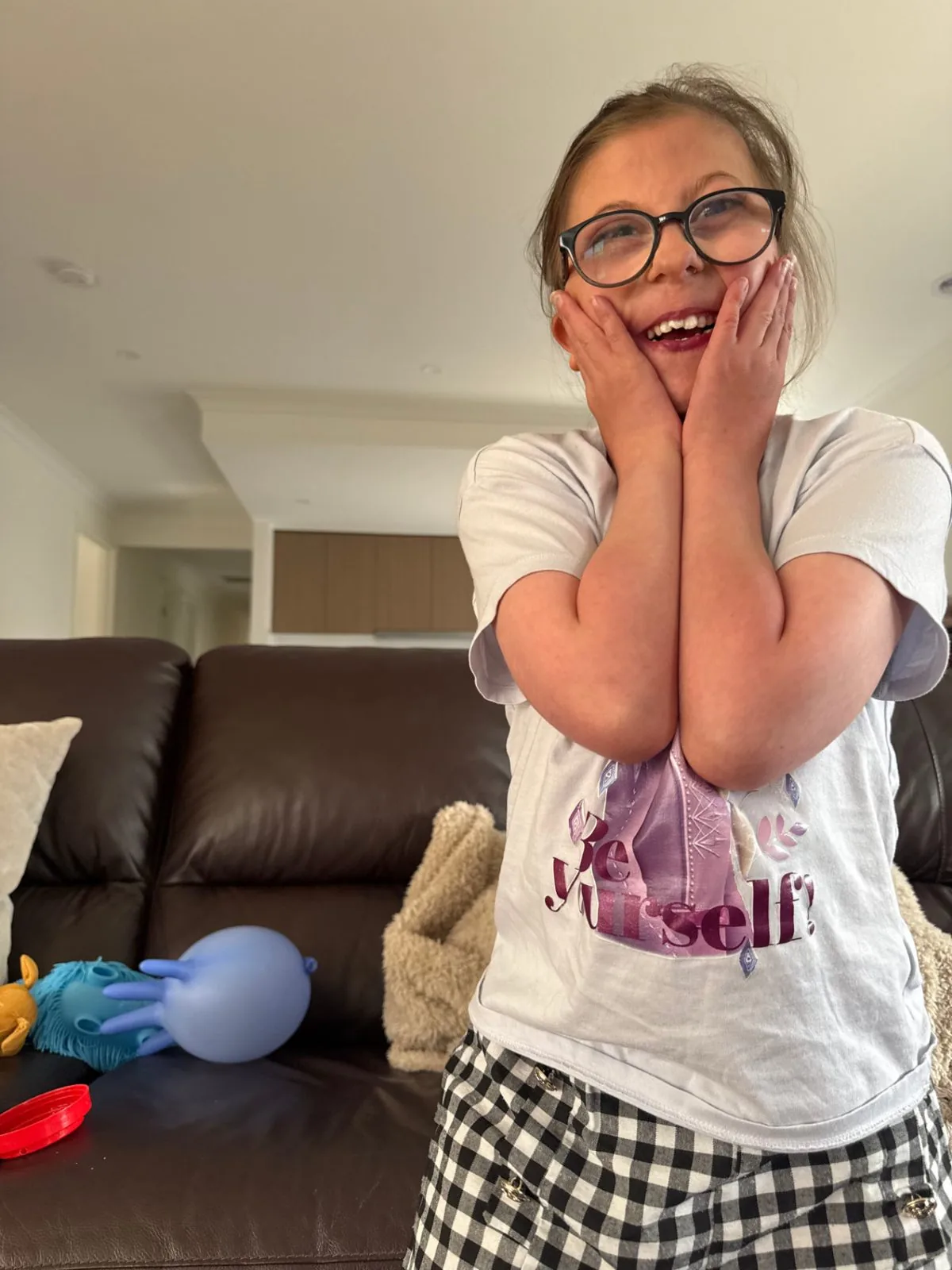 Participant laughing while playing with balloons at home